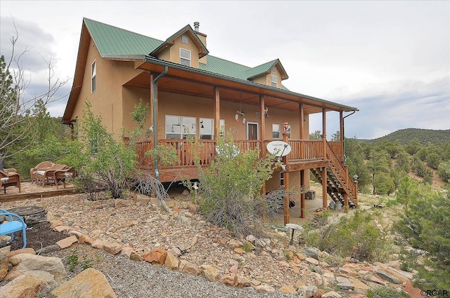 view of front of property with a mountain view and covered porch