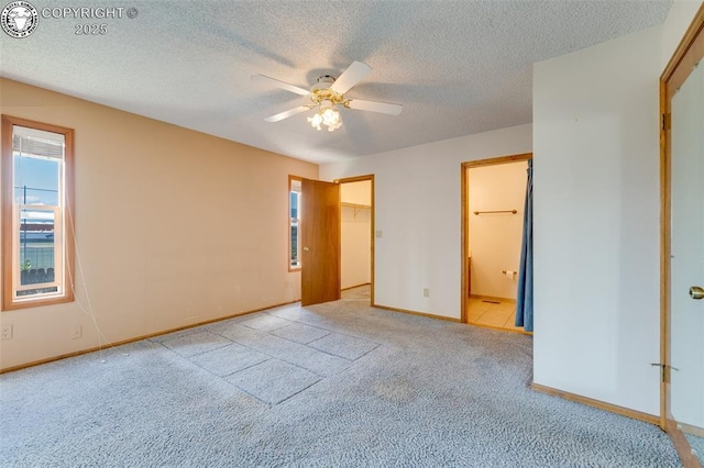 1108 Fairview Ave Unit B, Canon City, CO 81212 - unfurnished bedroom with carpet flooring, a textured ceiling, a spacious closet, ensuite bathroom, and a ceiling fan