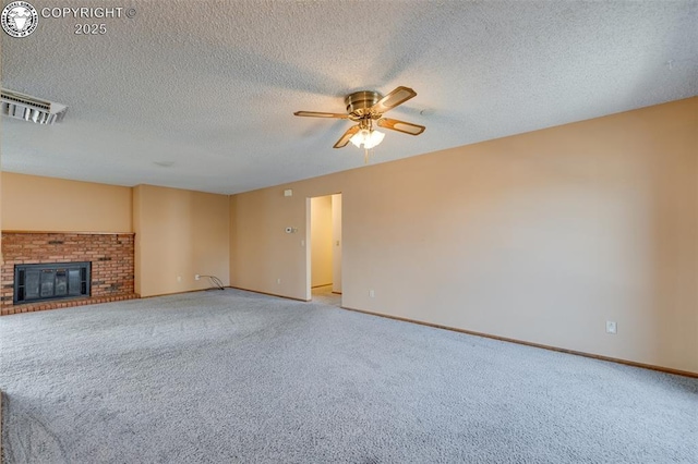 1108 Fairview Ave Unit B, Canon City, CO 81212 - unfurnished living room with light carpet, ceiling fan, a brick fireplace, and a textured ceiling