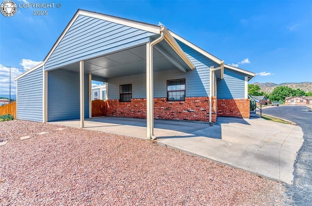 1108 Fairview Ave Unit B, Canon City, CO 81212 - back of house with brick siding, a mountain view, driveway, and a carport