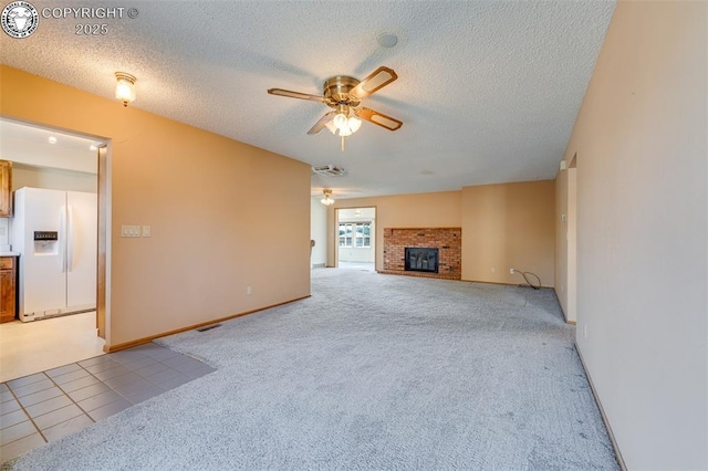 1108 Fairview Ave Unit B, Canon City, CO 81212 - unfurnished living room featuring a ceiling fan, light carpet, a fireplace, and a textured ceiling