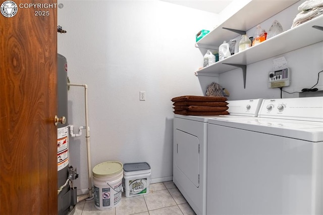 clothes washing area featuring washing machine and dryer and light tile patterned flooring