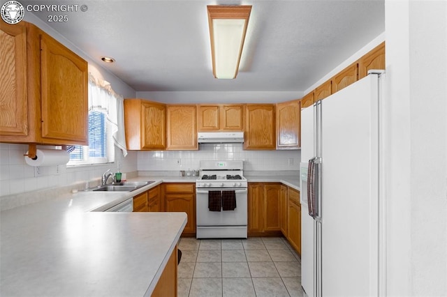 kitchen with backsplash, white appliances, sink, and light tile patterned floors