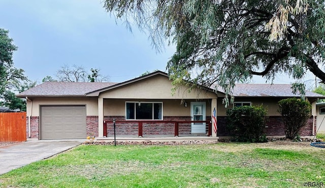 ranch-style house with a garage, covered porch, and a front yard