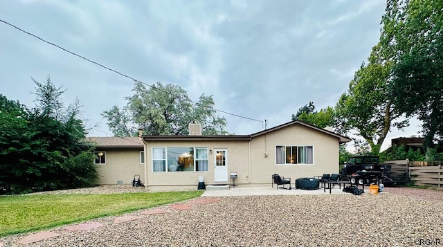 rear view of property with a yard and a patio