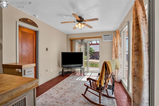 925 2nd St, Penrose, CO 81240 - living area featuring dark tile patterned flooring, ceiling fan, and a wall mounted AC