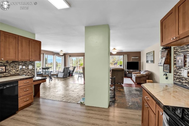 925 2nd St, Penrose, CO 81240 - kitchen featuring open floor plan, tile counters, black dishwasher, and backsplash