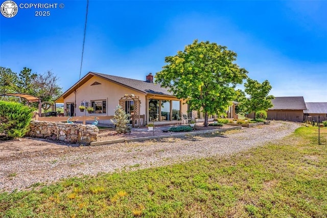 925 2nd St, Penrose, CO 81240 - rear view of property with a patio, a chimney, a yard, and stucco siding