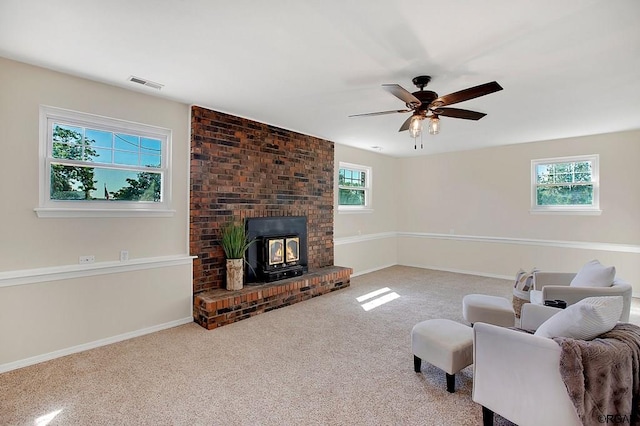 living room with ceiling fan, a healthy amount of sunlight, and light carpet