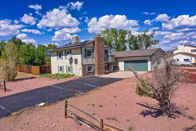 view of front of home with central AC unit and solar panels