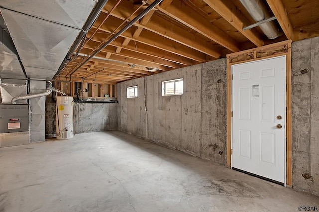 basement featuring heating unit and gas water heater