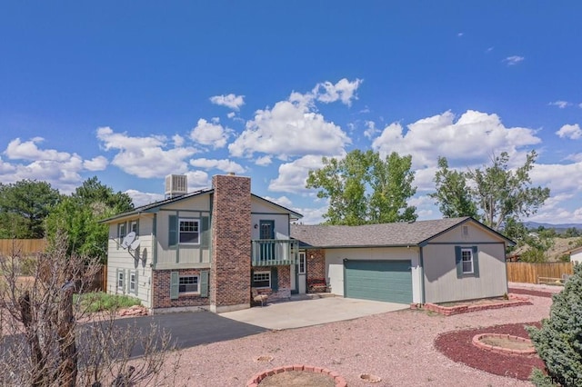 view of front of home featuring a garage and central air condition unit