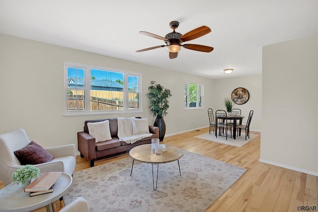 living room featuring light hardwood / wood-style floors and ceiling fan