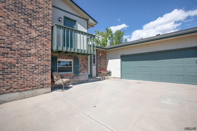 exterior space featuring a garage and a balcony