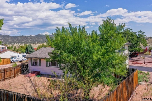 view of property exterior with a mountain view