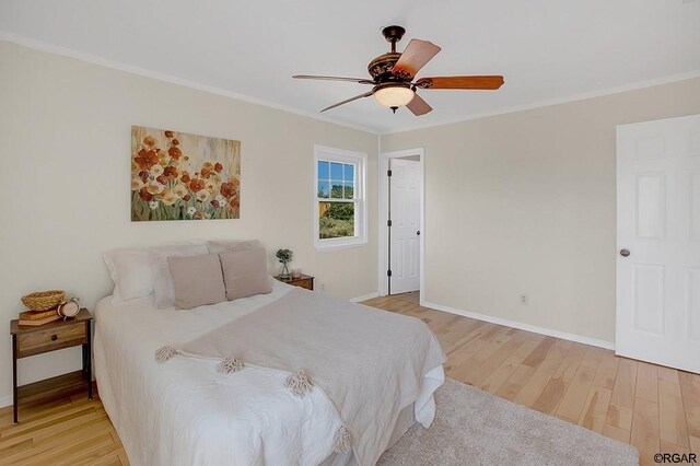 bedroom featuring light hardwood / wood-style flooring, ornamental molding, and ceiling fan