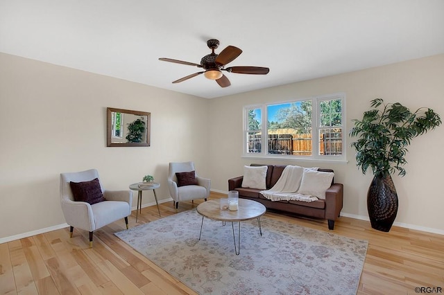 living room with ceiling fan and light hardwood / wood-style floors