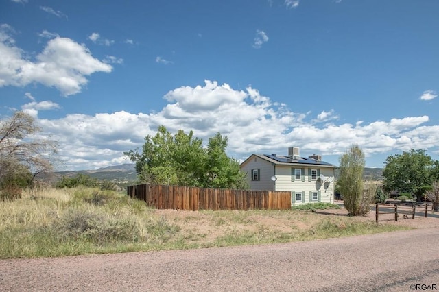 view of side of property with solar panels