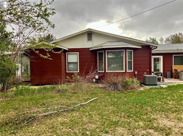 exterior space featuring a yard and cooling unit