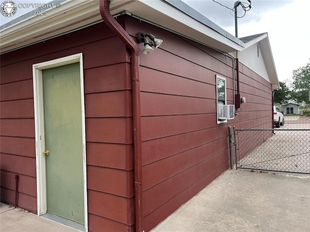 view of side of home featuring fence