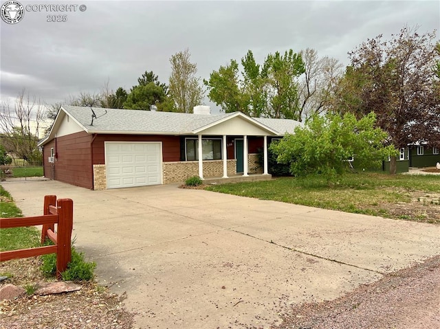 ranch-style home featuring roof with shingles, a front yard, brick siding, concrete driveway, and an attached garage