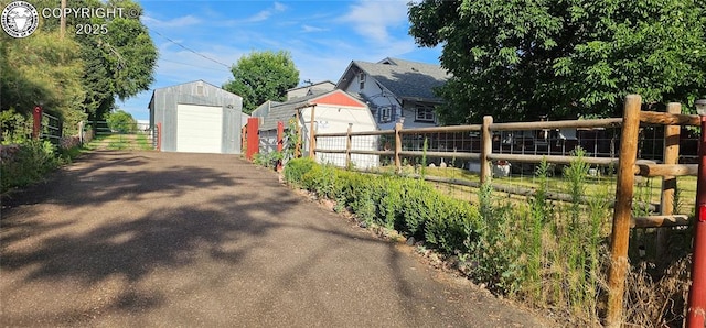 1540 Lombard St, Canon City, CO 81212 - view of yard with an outbuilding, a garage, and asphalt driveway