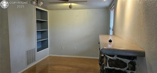 1540 Lombard St, Canon City, CO 81212 - unfurnished office with built in shelves, wood finished floors, and a textured wall