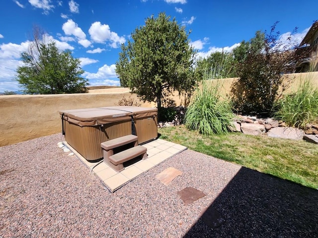 view of yard with a hot tub and a patio