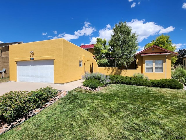 view of front of home with a garage and a front yard