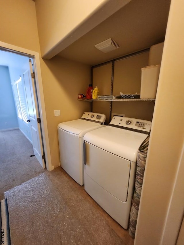 laundry room featuring light colored carpet and separate washer and dryer