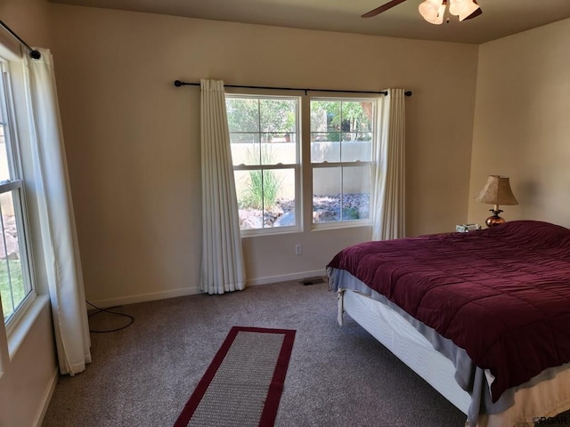 bedroom with multiple windows, carpet floors, and ceiling fan