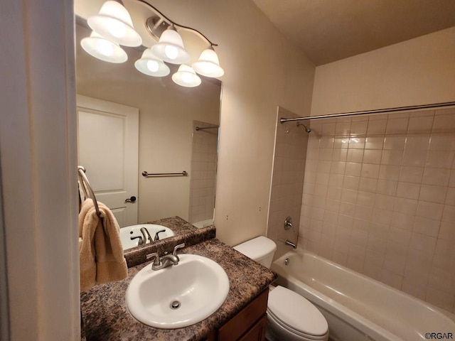 full bathroom with vanity, tiled shower / bath combo, and toilet