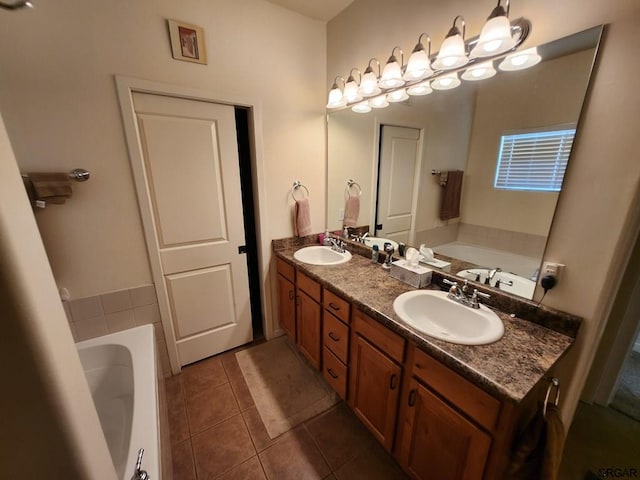 bathroom with tile patterned flooring, vanity, and a bathing tub