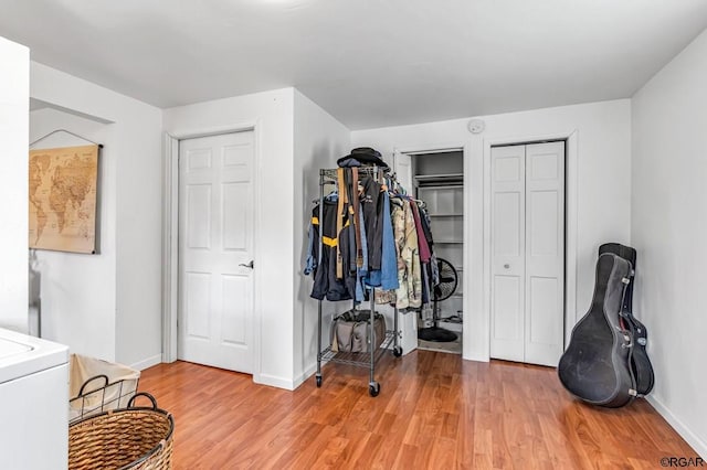 interior space with hardwood / wood-style flooring and multiple closets