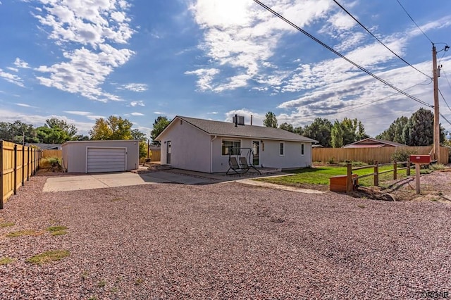 back of property with an outbuilding and a patio