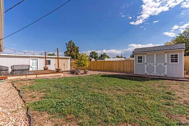 view of yard with a deck and a shed