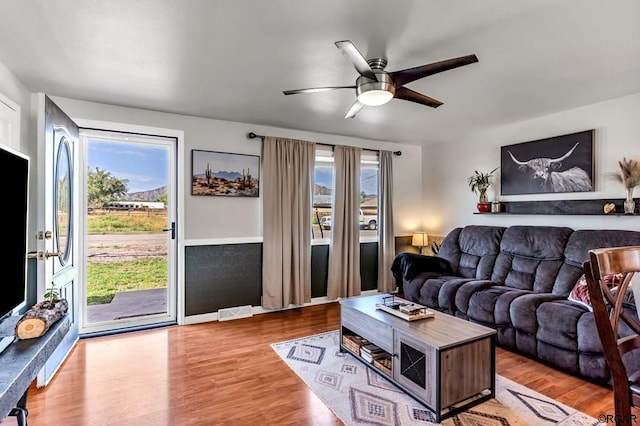 living room featuring light hardwood / wood-style floors and ceiling fan