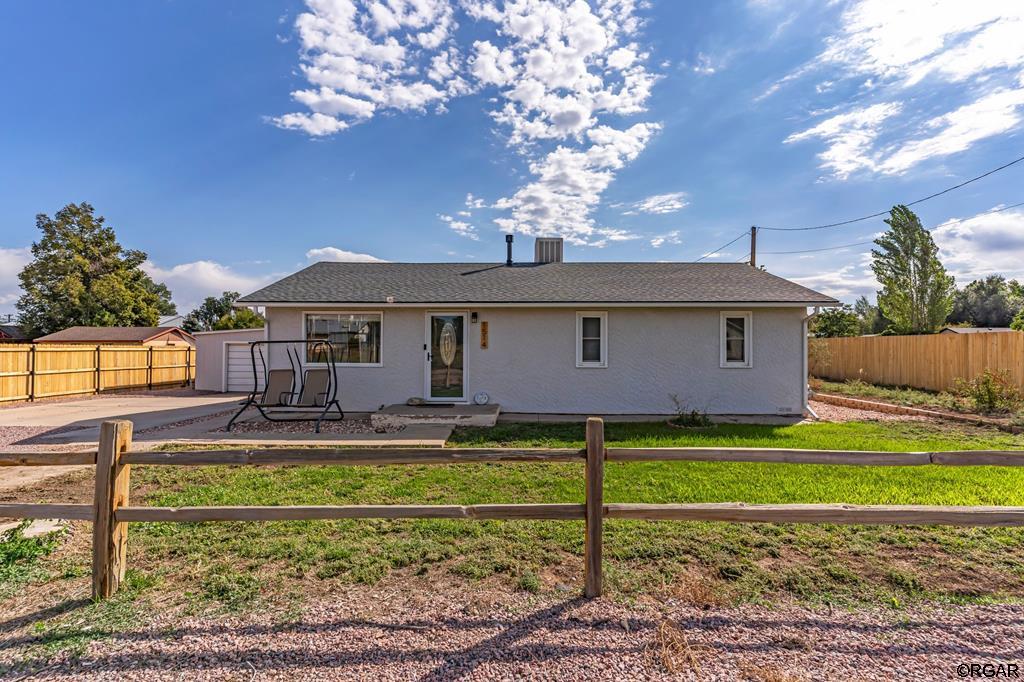 rear view of property featuring central AC unit