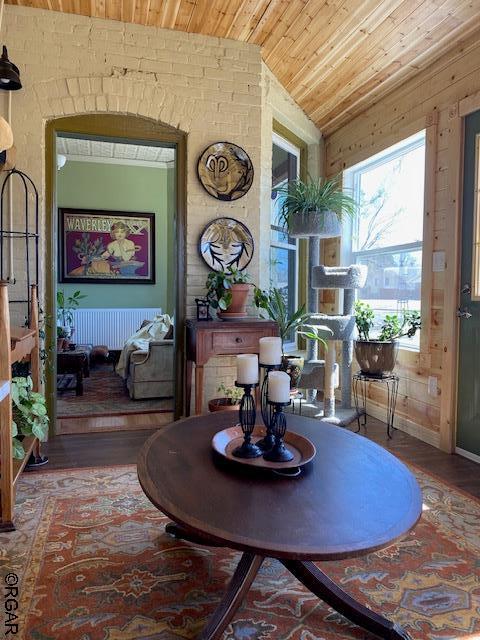 dining area with wood ceiling, lofted ceiling, and radiator