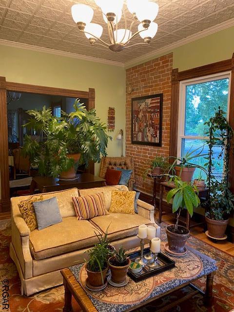 living room featuring ornamental molding and a chandelier