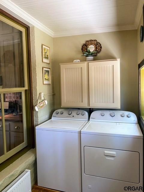 washroom with cabinets, crown molding, separate washer and dryer, and radiator heating unit