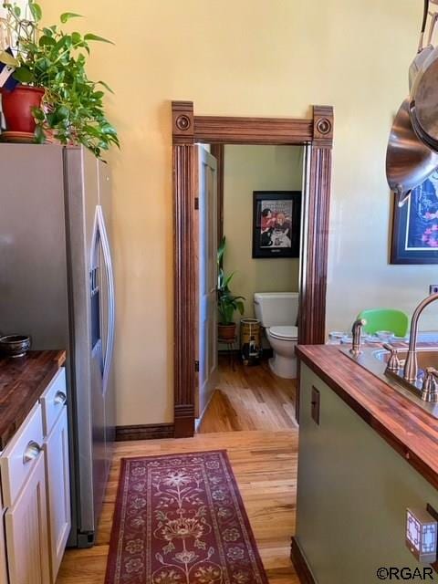 interior space featuring vanity, toilet, and hardwood / wood-style floors