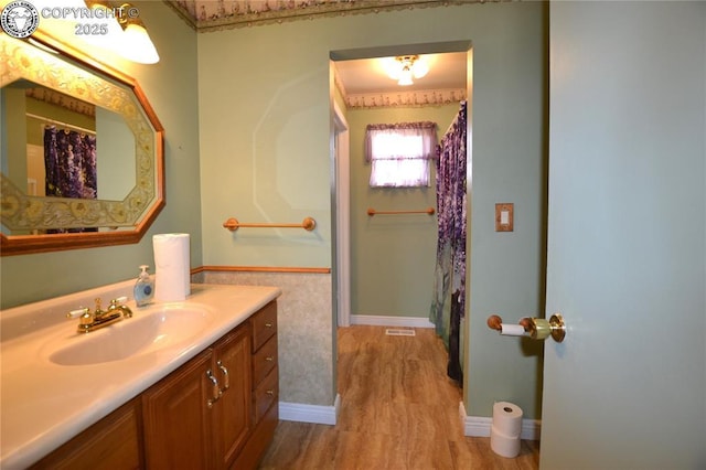 full bathroom with vanity, baseboards, and visible vents