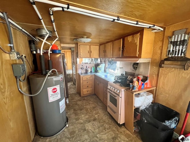 kitchen with sink, white gas range oven, and water heater