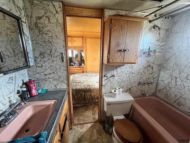 full bathroom featuring vanity, bathtub / shower combination, and toilet