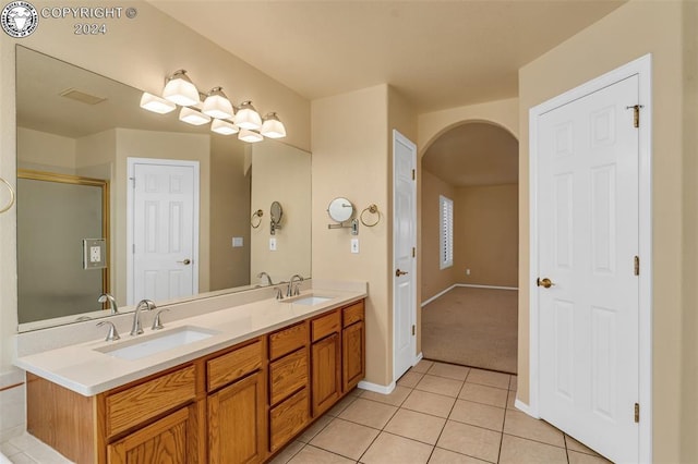 bathroom with vanity, a shower with door, and tile patterned floors