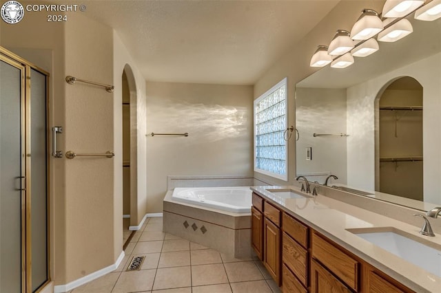 bathroom featuring vanity, shower with separate bathtub, and tile patterned flooring