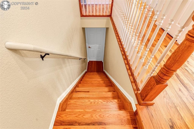 stairs with wood-type flooring