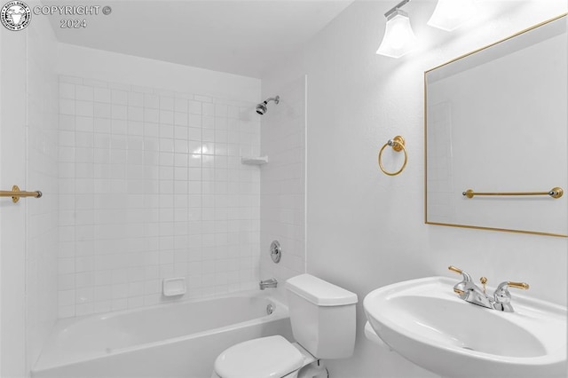 full bathroom featuring sink, bathtub / shower combination, and toilet