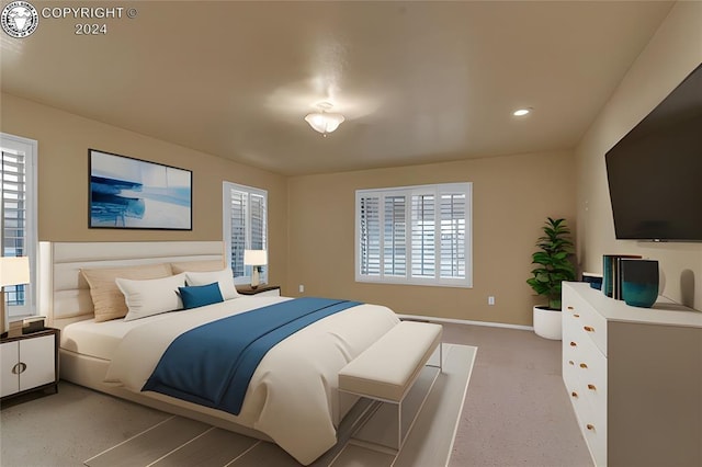 bedroom with light colored carpet and multiple windows